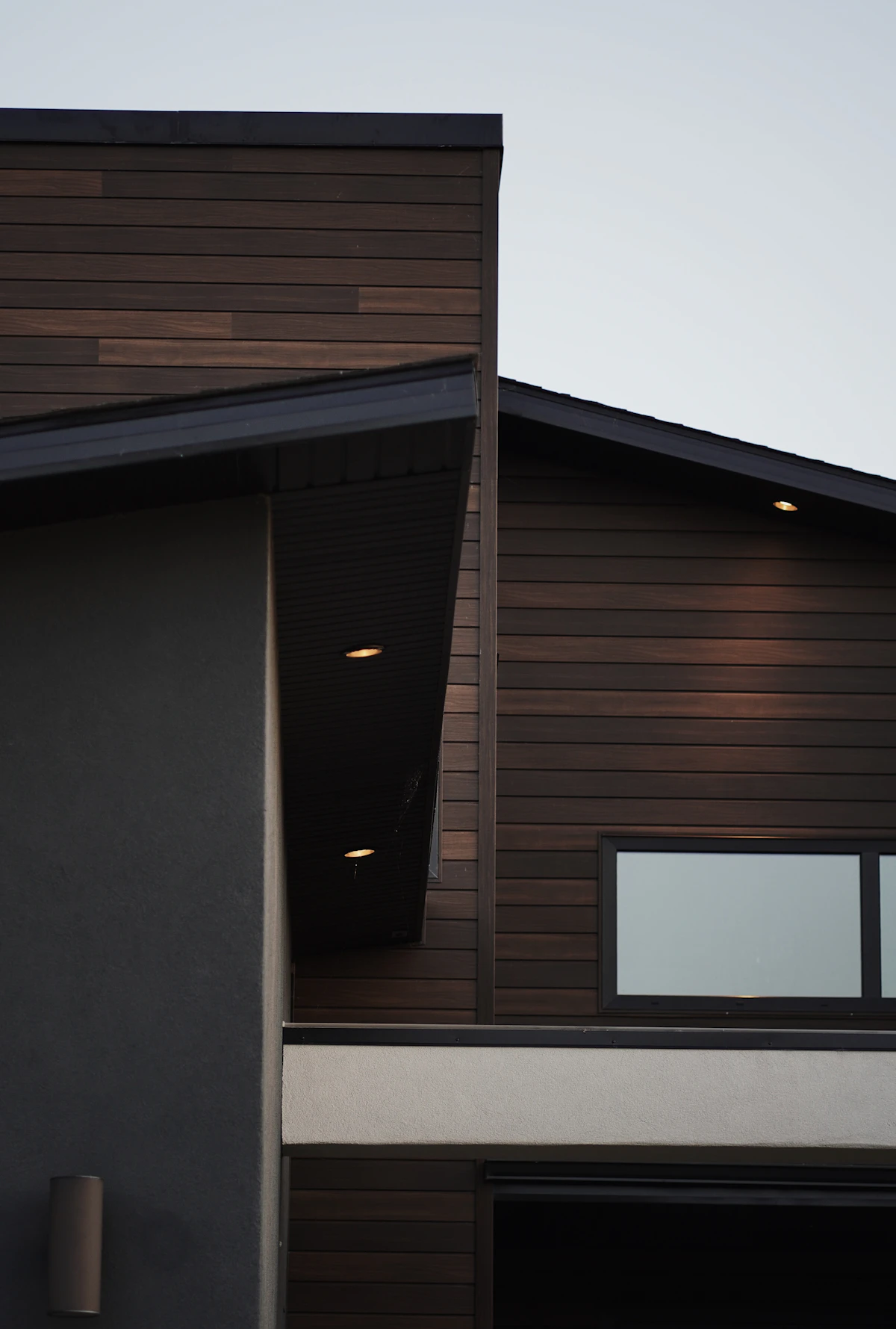 Sleek modern dark wood-panel siding after replacement