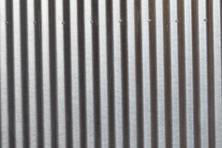A close up of a metal wall with vertical lines