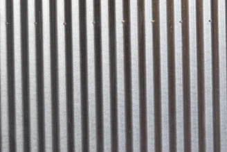 A close up of a metal wall with vertical lines