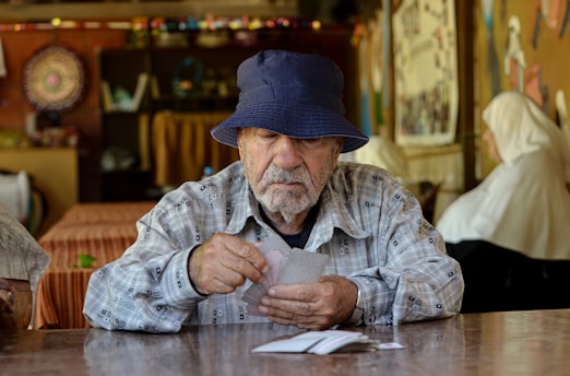 A man sitting at a table with a hat on