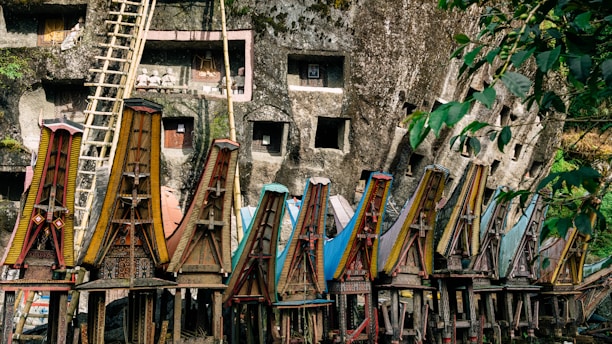A bunch of wooden chairs sitting in front of a cliff