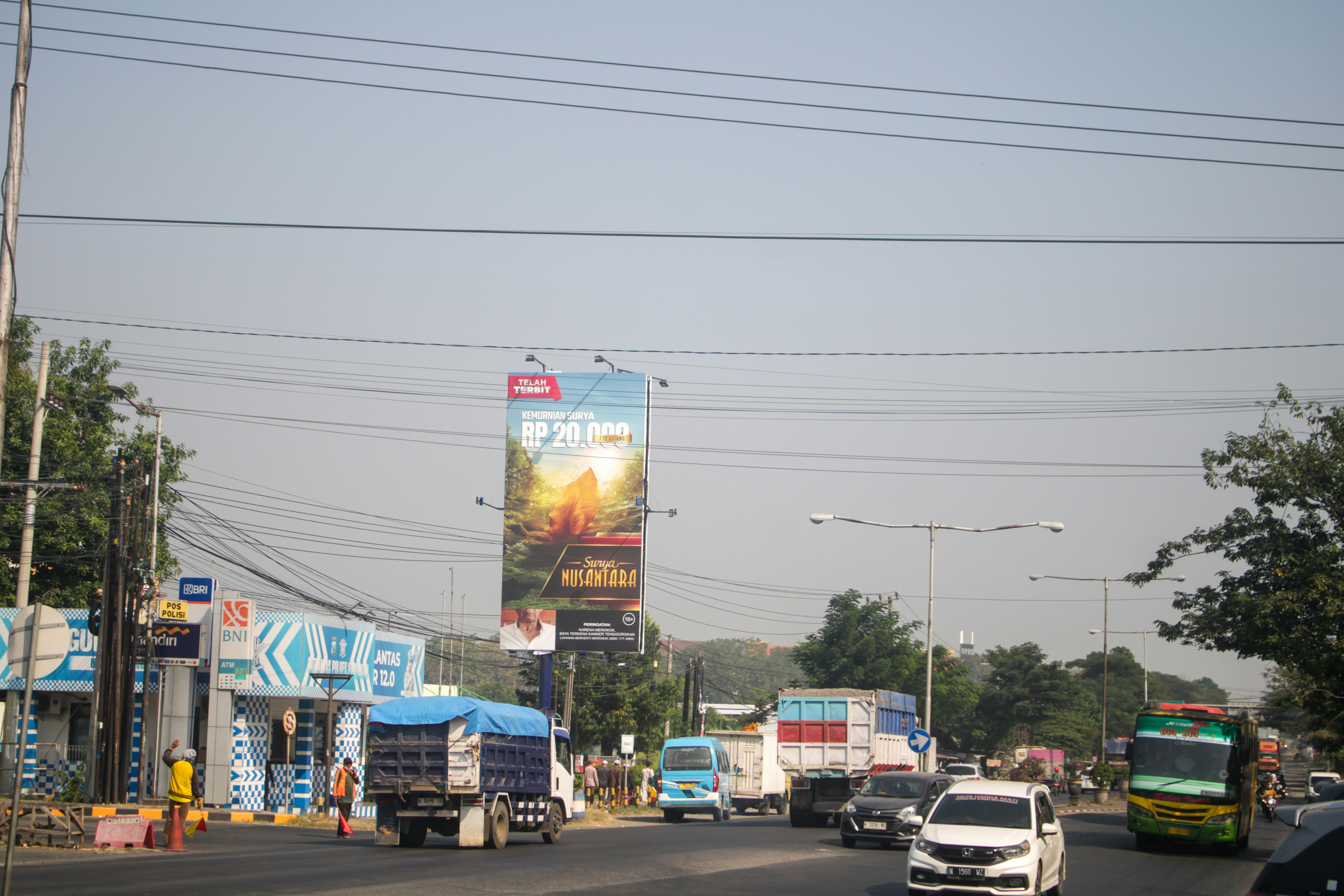 Large billboard hoarding on highway with brand advertisement