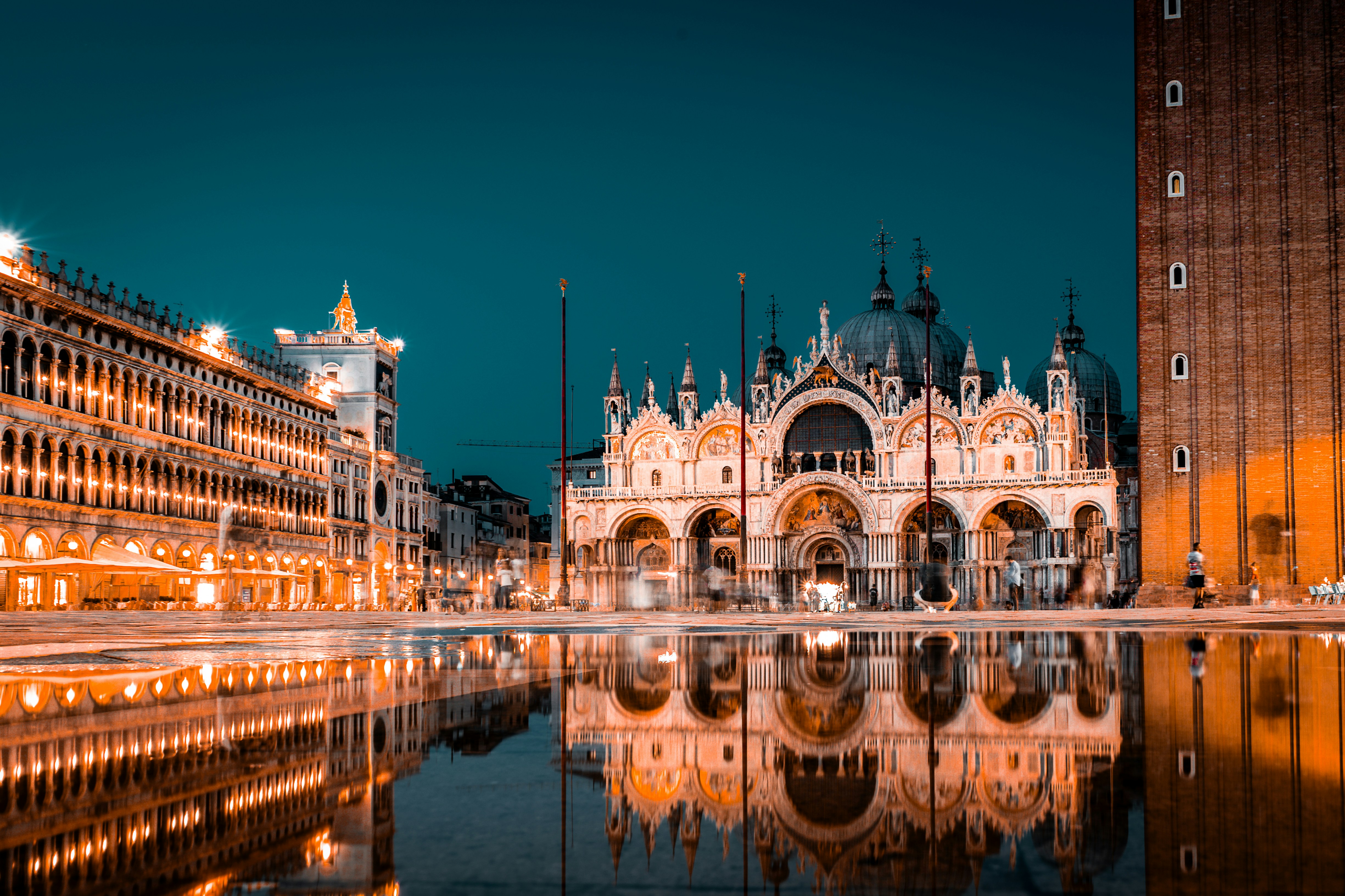 A reflection of a building in a body of water