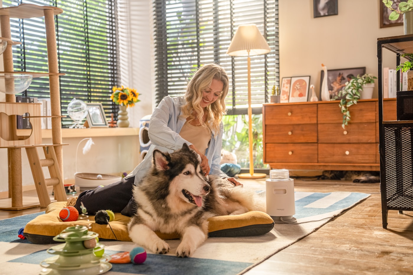 A woman sitting on the floor with her dog