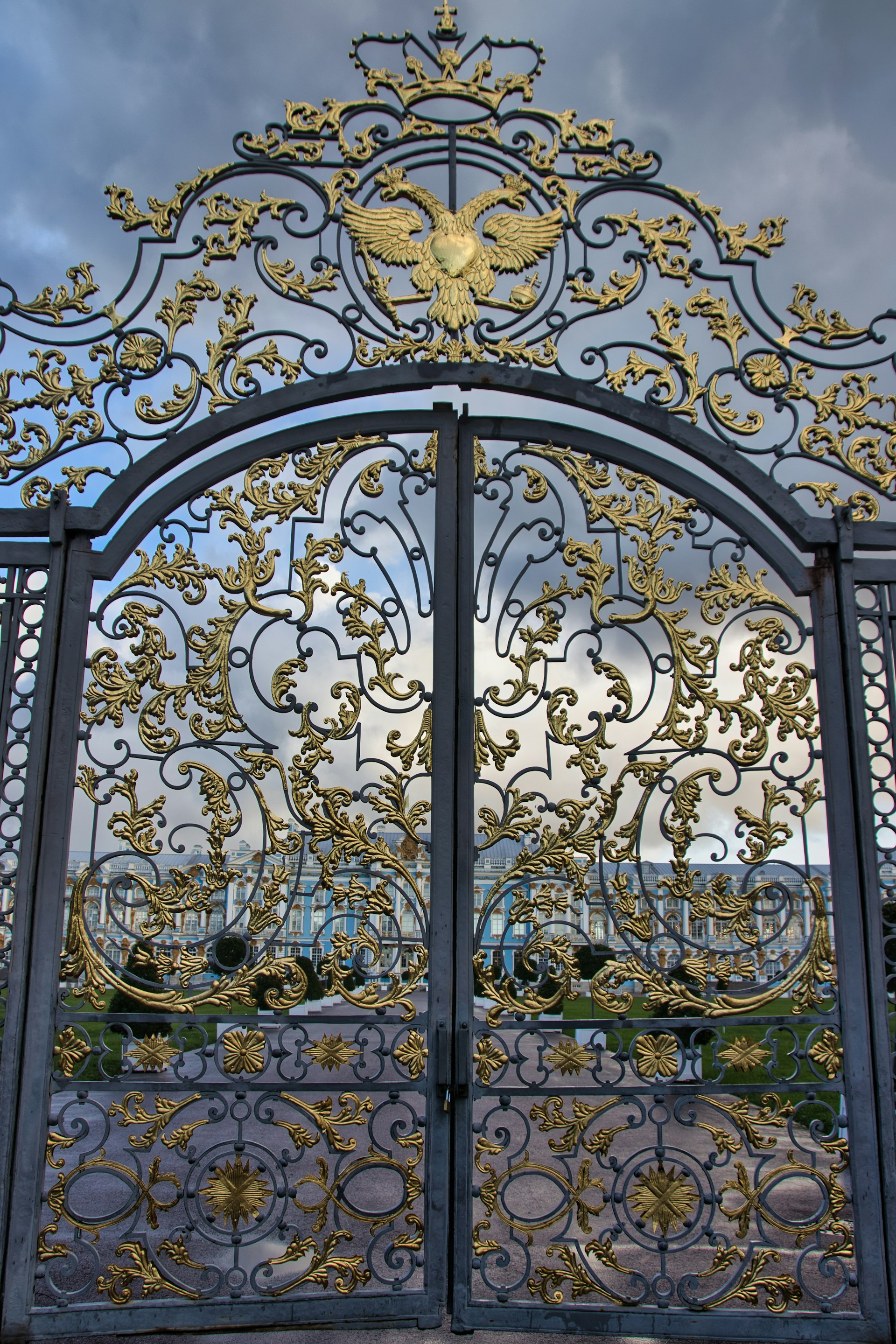 A large metal gate with gold designs on it