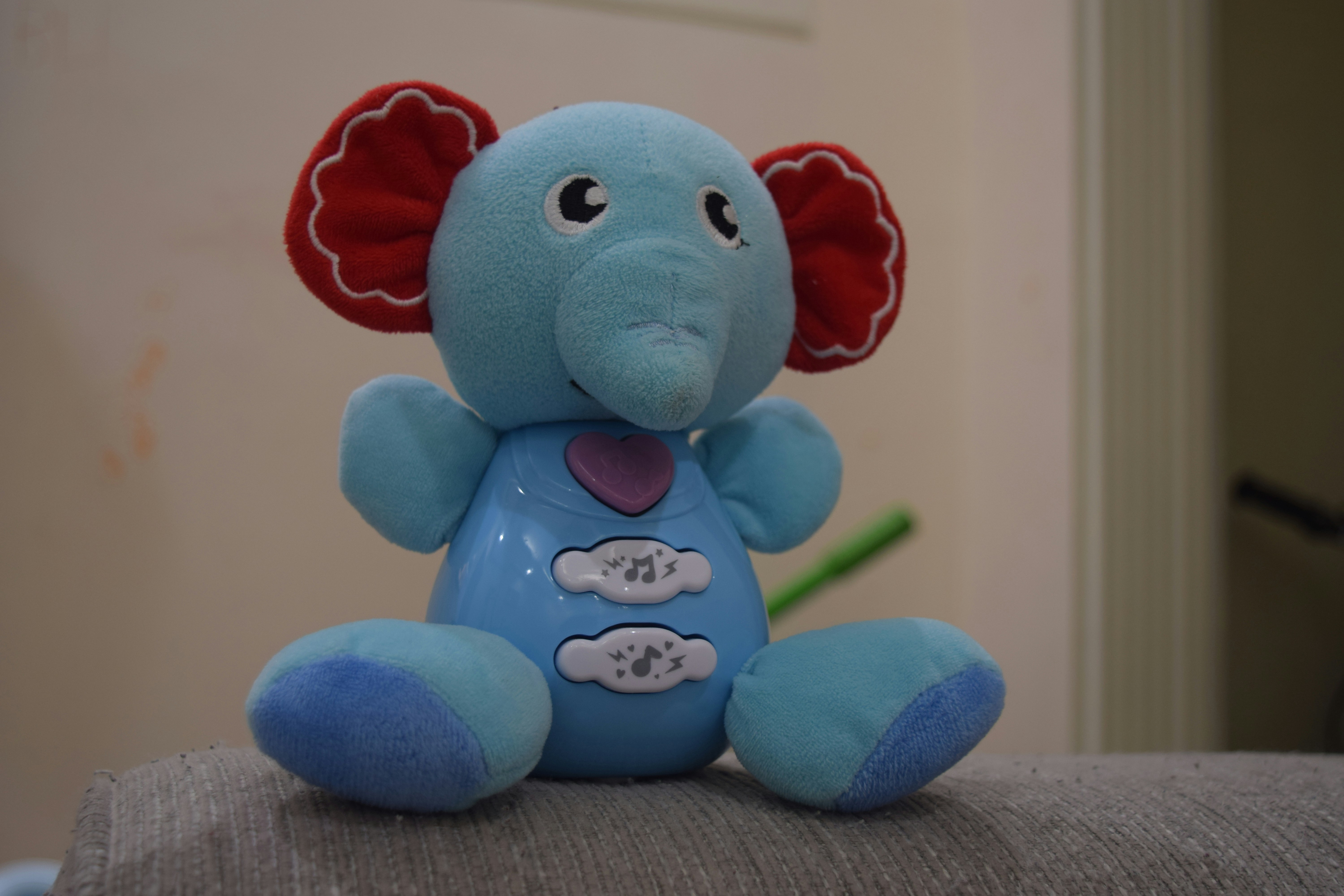 Interactive musical elephant plush toy in gray with colorful ears, suitable for babies 6 months to 2 years