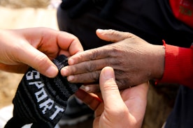 A person holding a pair of shoes in their hands
