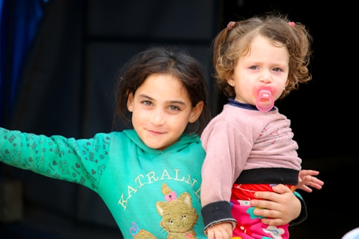Two little girls standing next to each other
