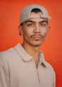 A man with a mustache wearing a hat