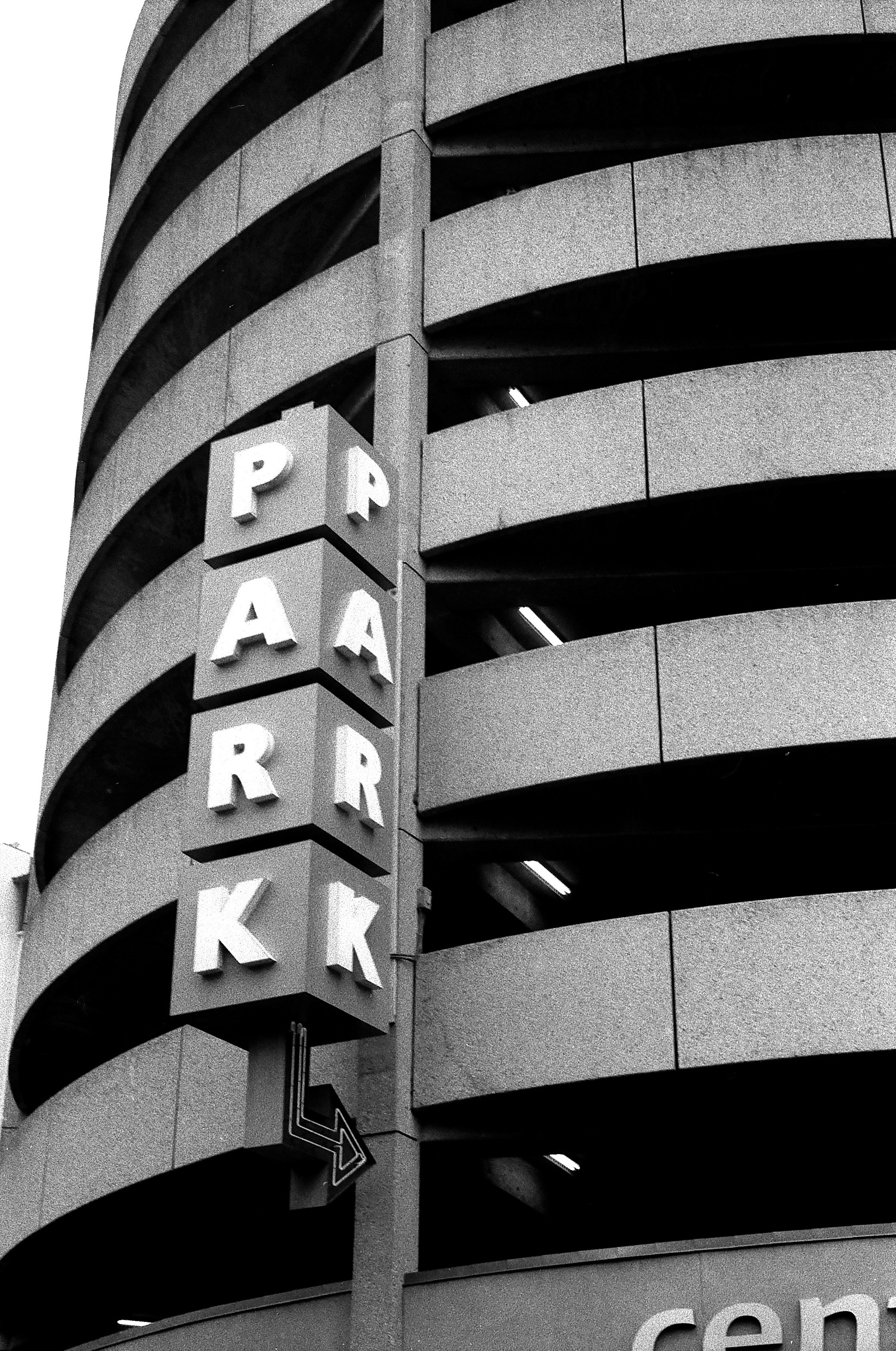 A black and white photo of a parking garage