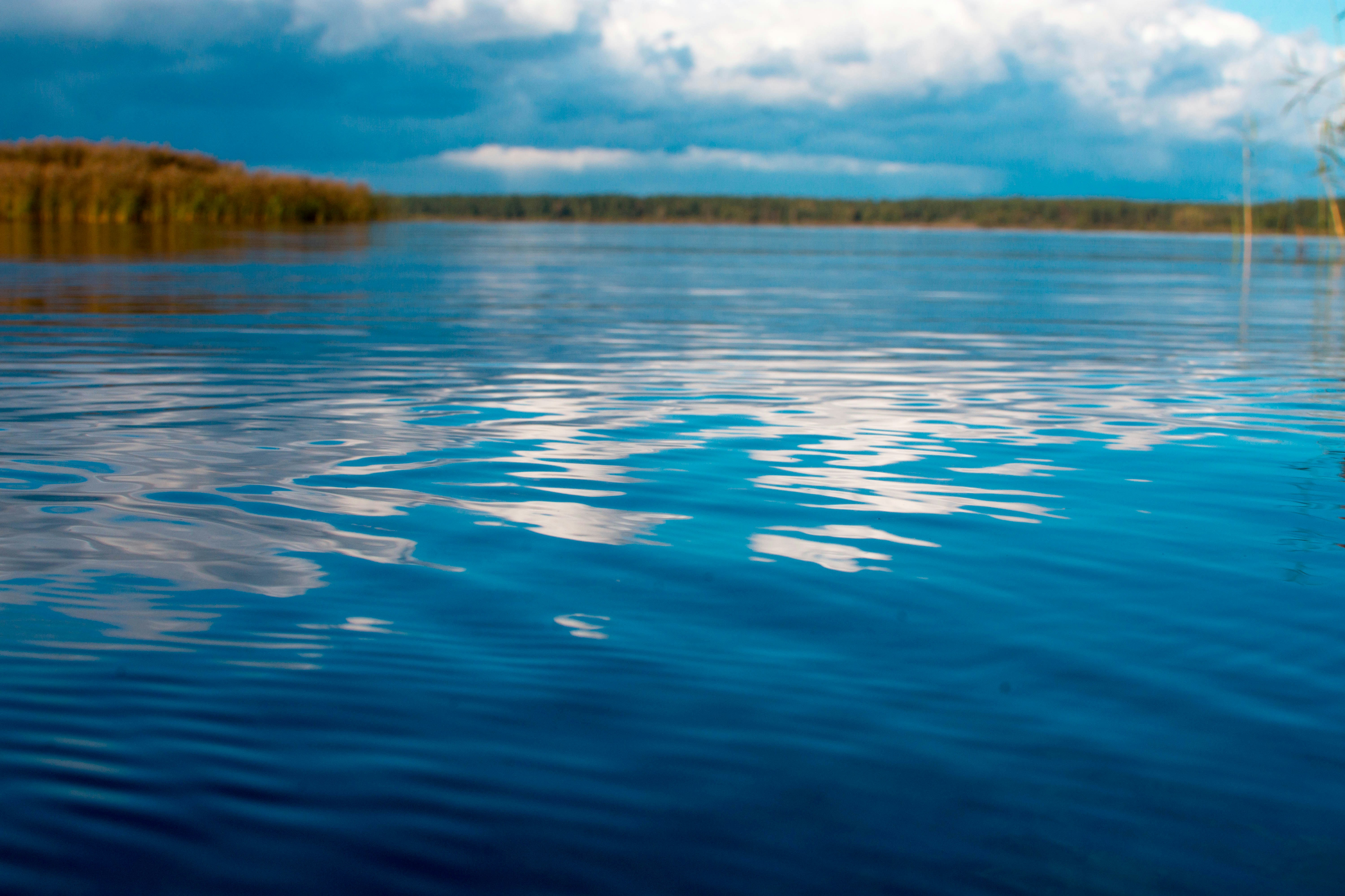 blue water and sky with shoreline in the distance