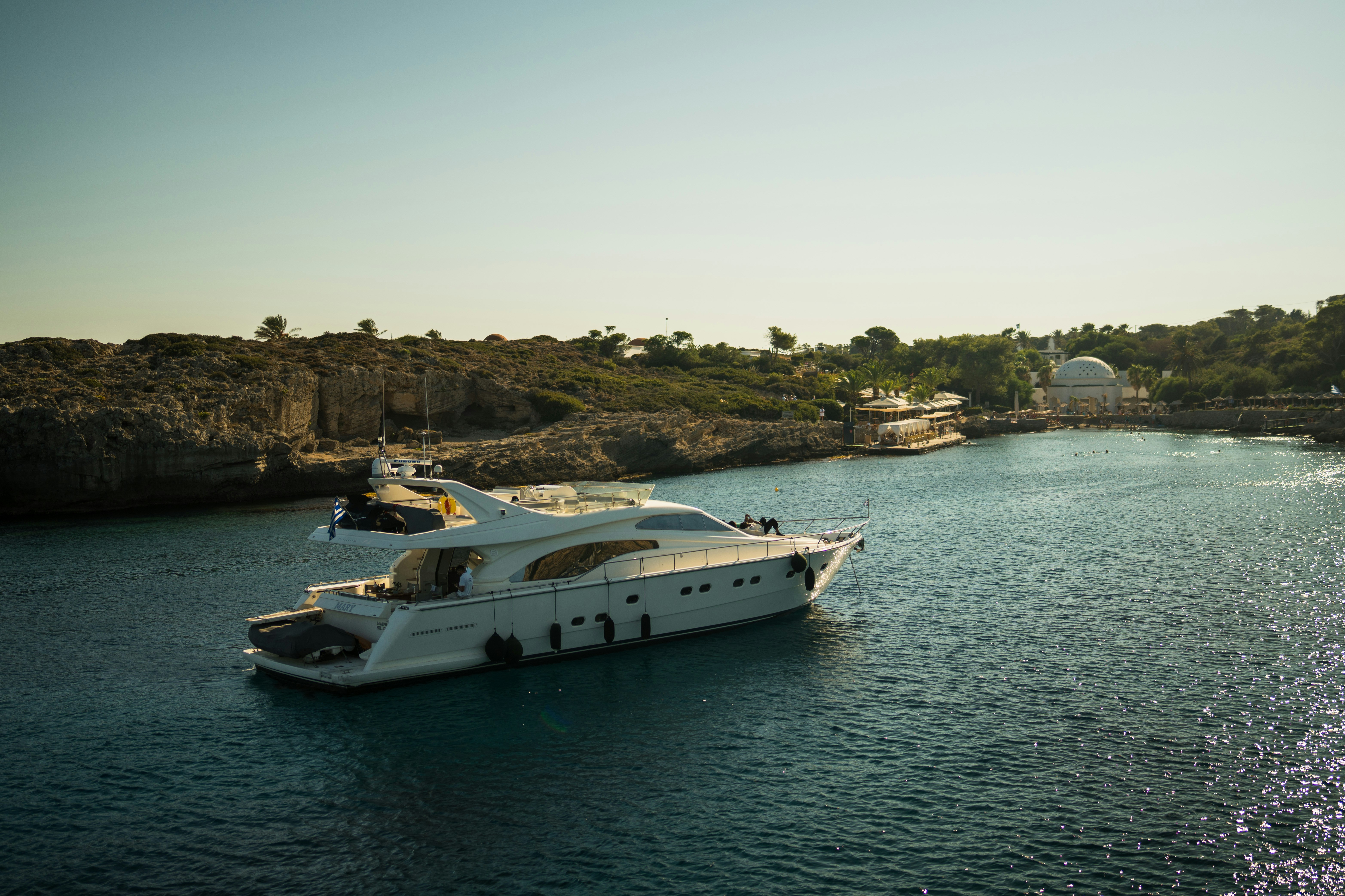 A large white boat floating on top of a body of water