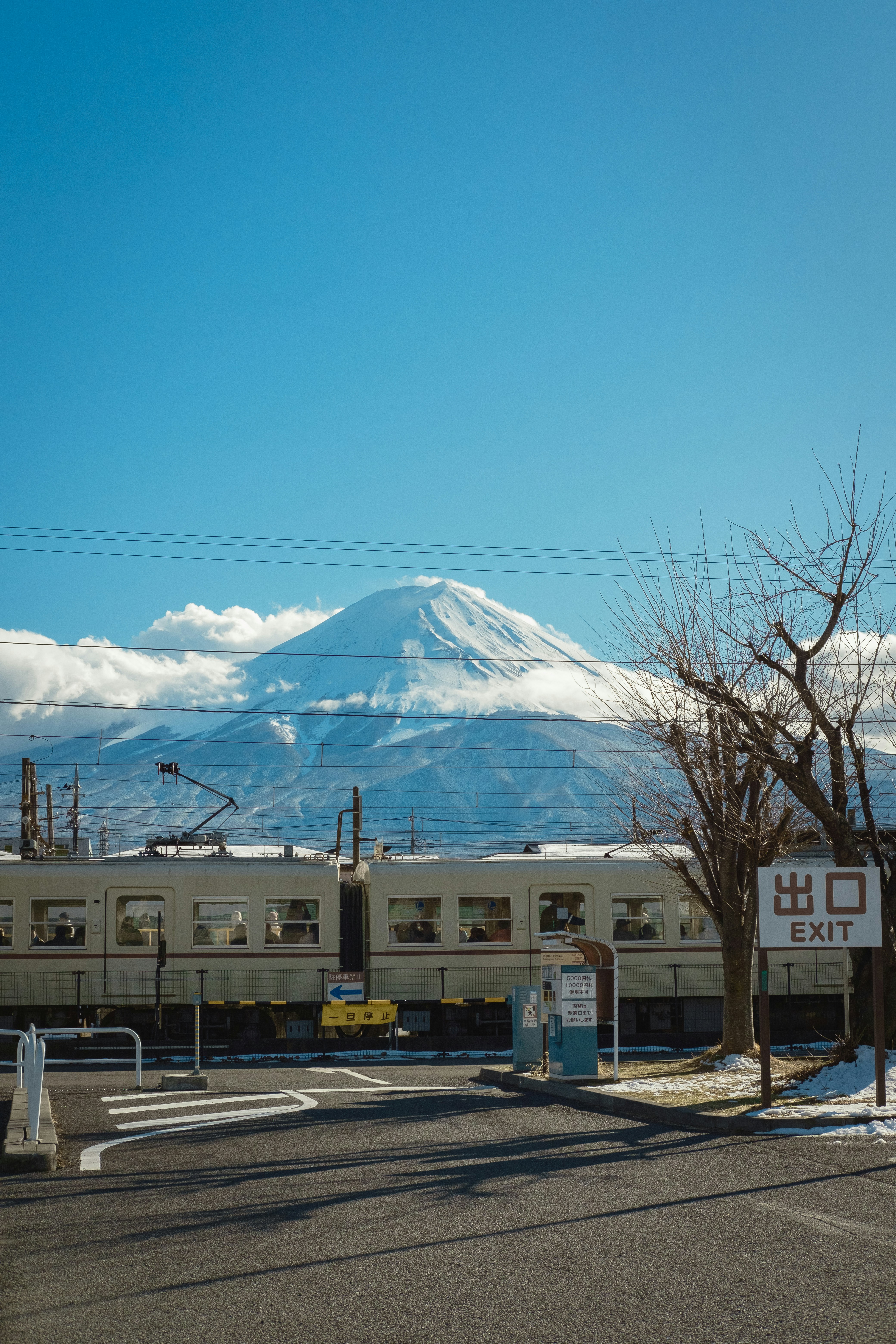 A train traveling past a snow covered mountain