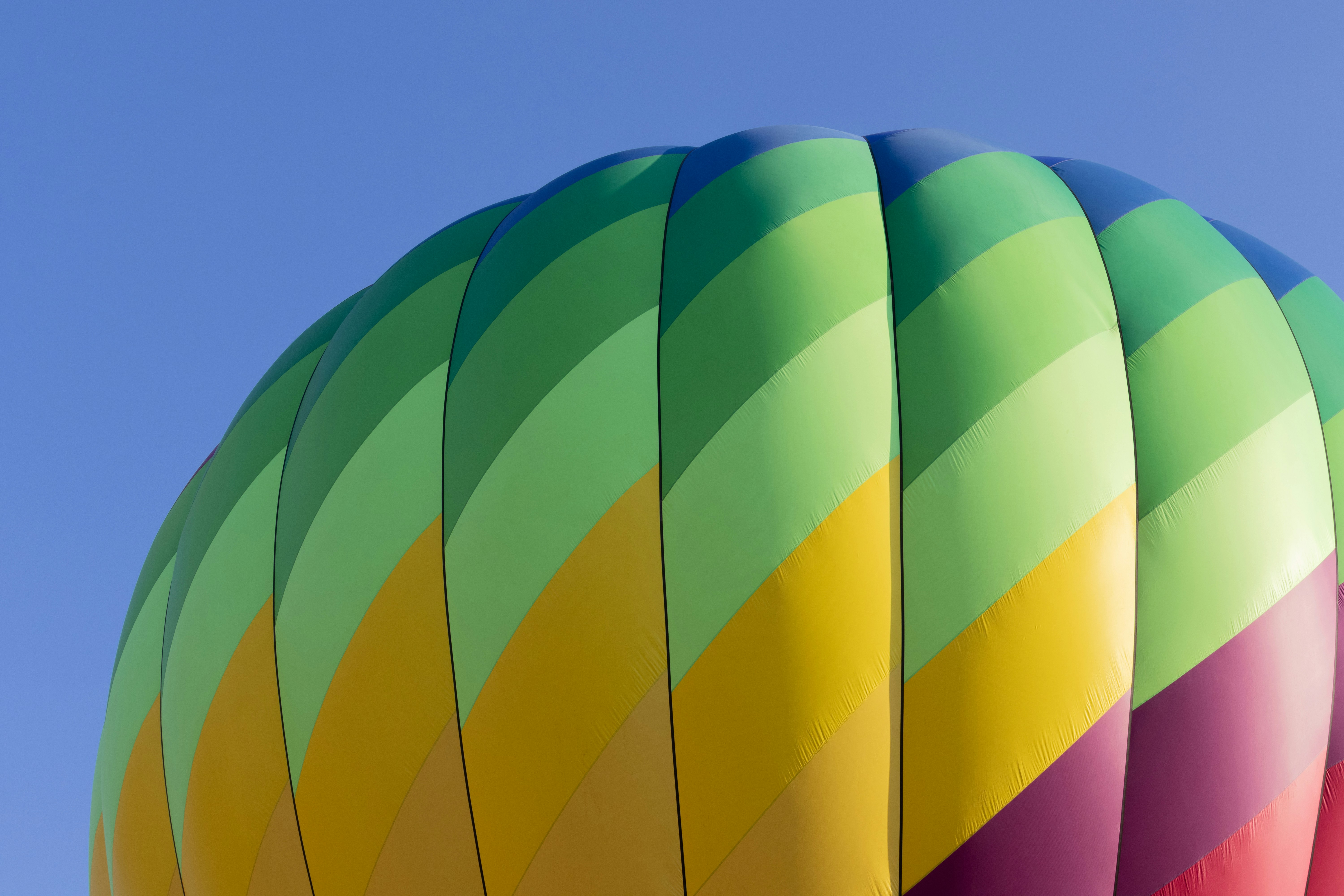 Colorful hot air balloon flying in blue sky
