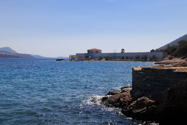 A body of water with a building in the background