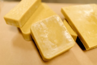 A couple of pieces of cheese sitting on top of a table