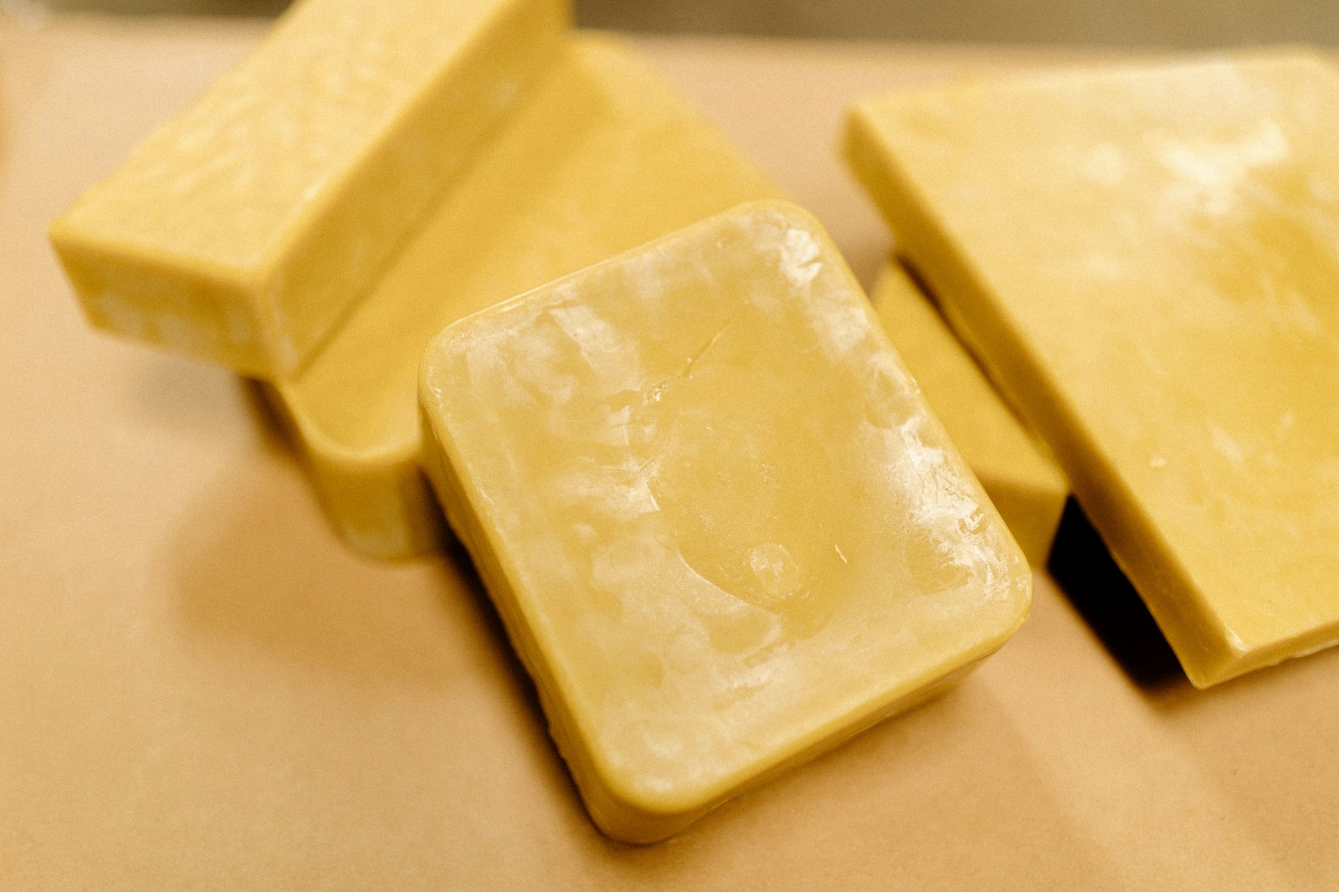 A couple of pieces of cheese sitting on top of a table