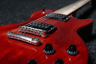 A close up of a red electric guitar