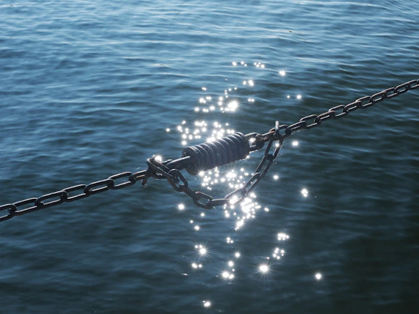 Anchor chain rode running over the bow of a cruising sailboat