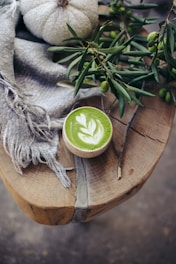 A cup of green tea on a wooden table