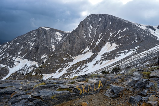 A man standing on top of a snow covered mountain