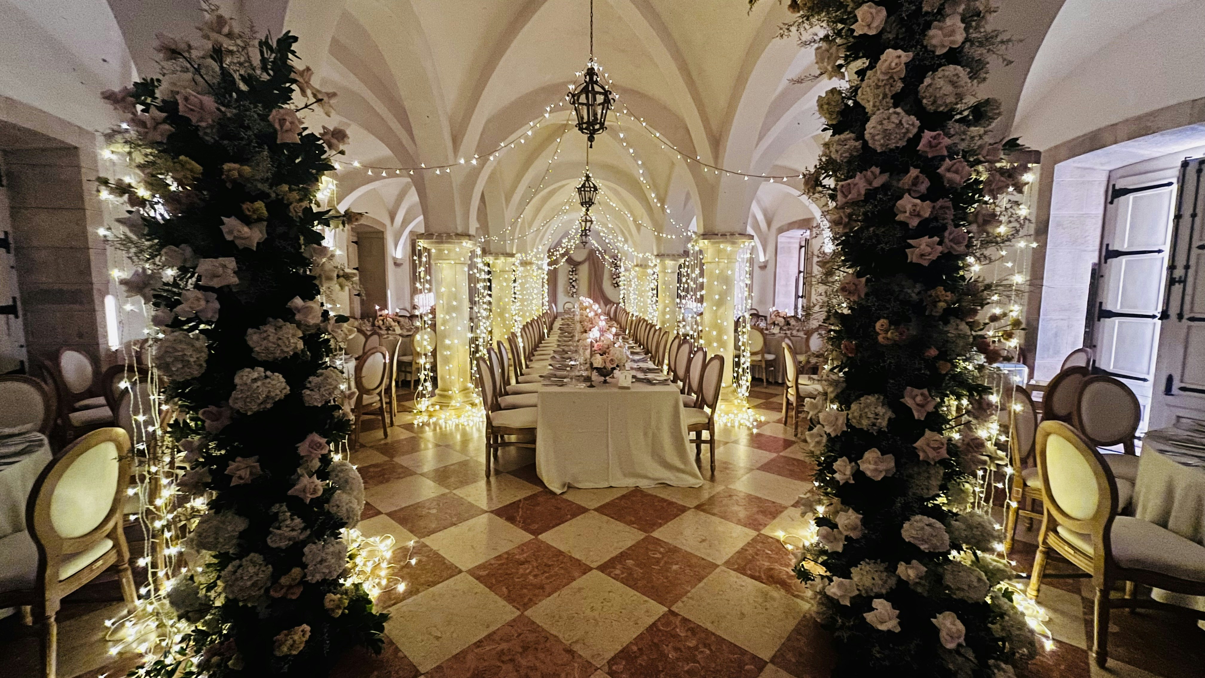 Private hall with fairy lights and elegantly draped tables for a birthday event