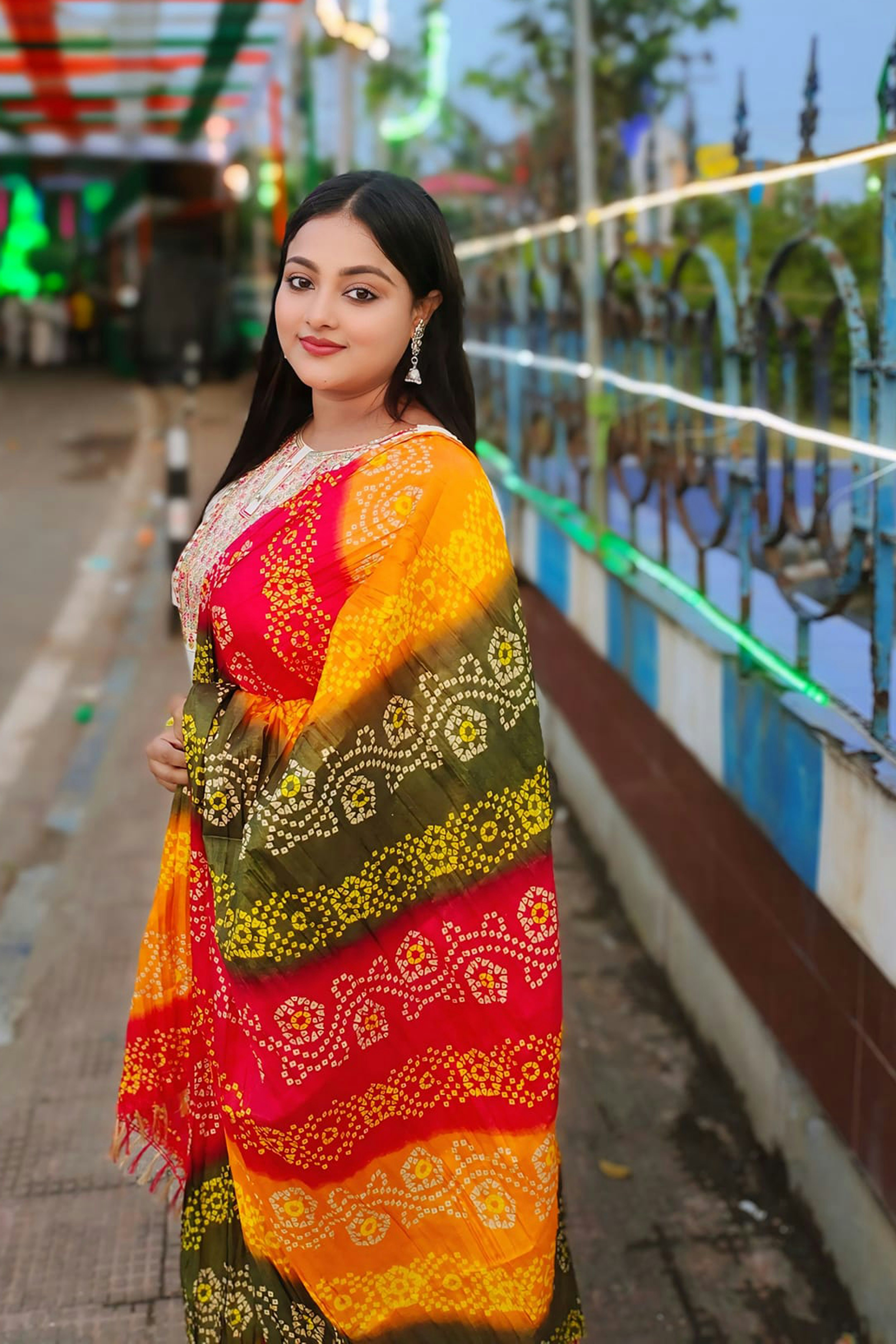 Young South Asian woman with bright smile and earrings