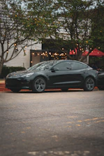A black car parked on the side of the road