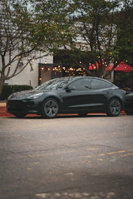 A black car parked on the side of the road