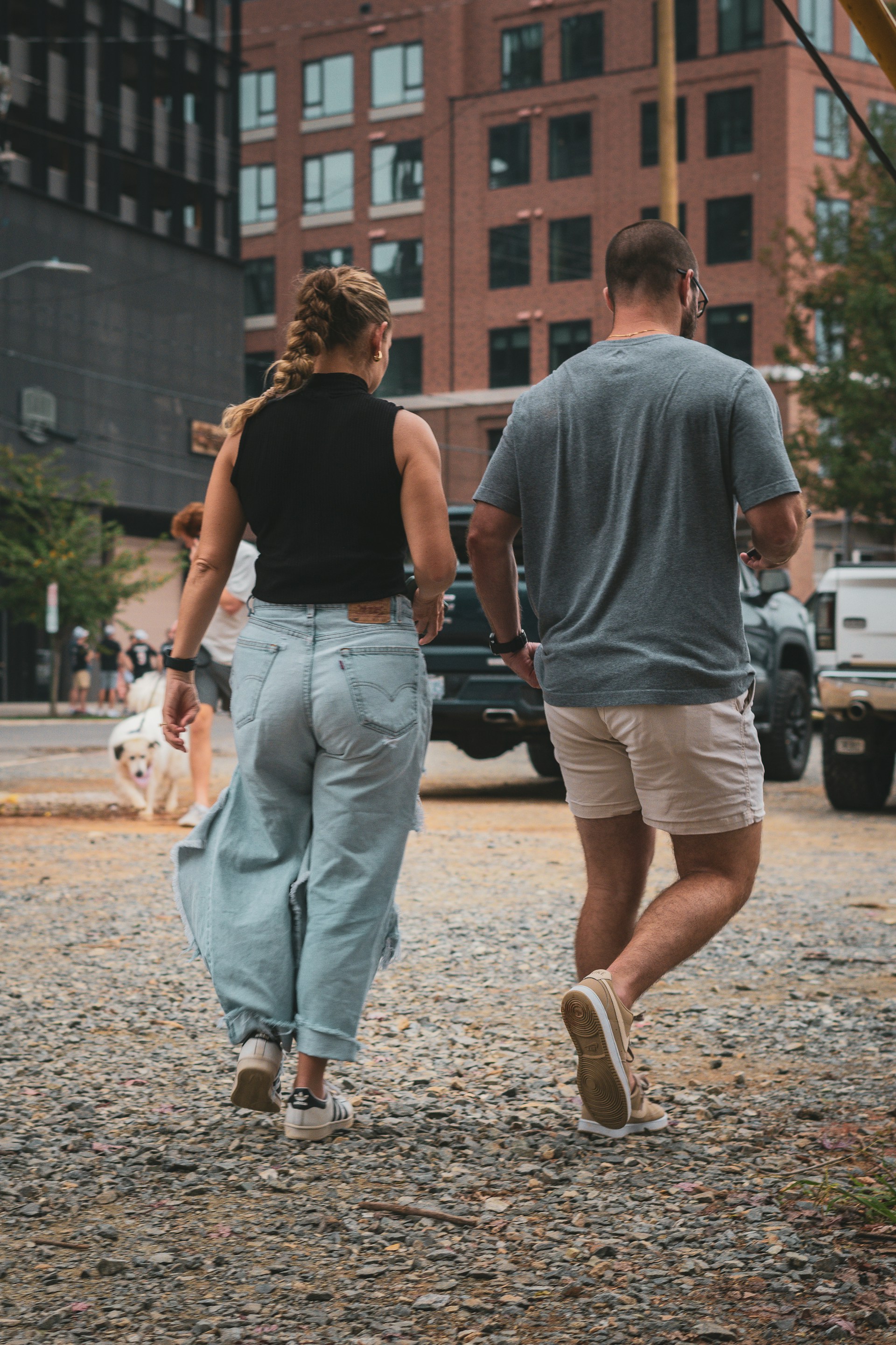 A man and a woman walking down a street