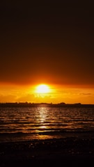 The sun is setting over a body of water