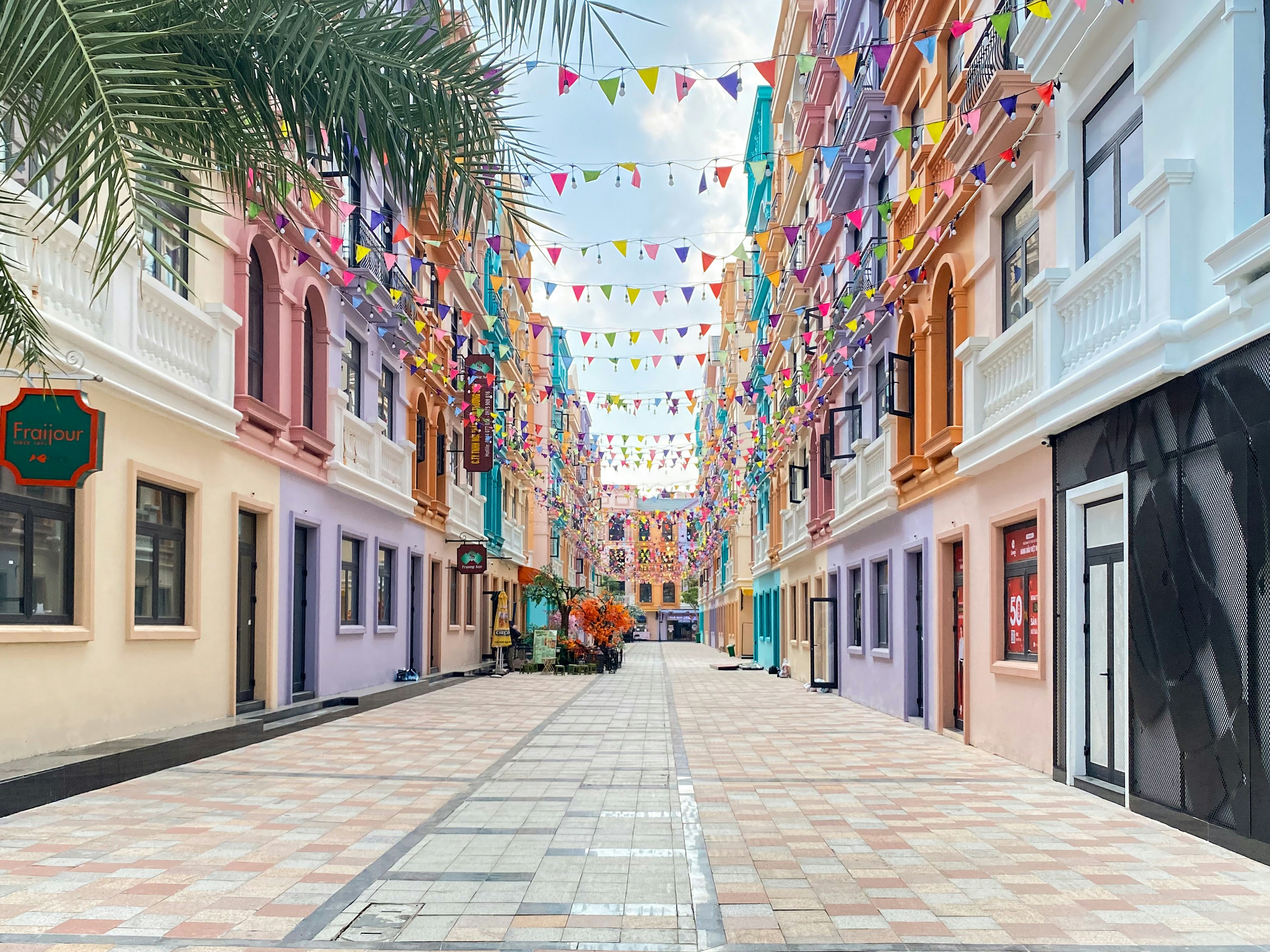 A street lined with buildings and palm trees