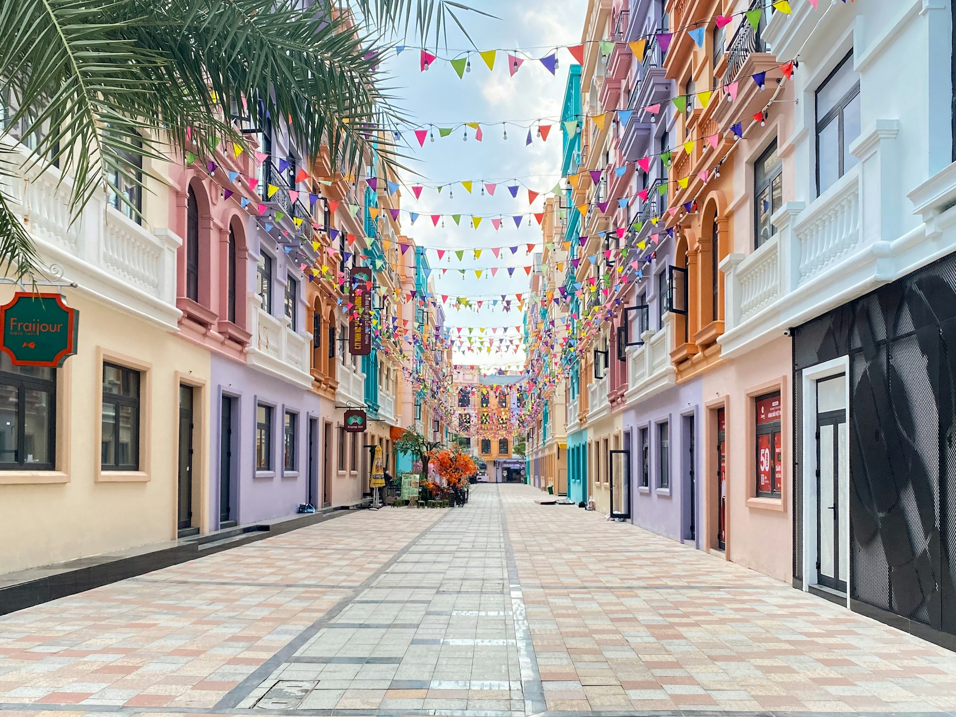 A street lined with buildings and palm trees