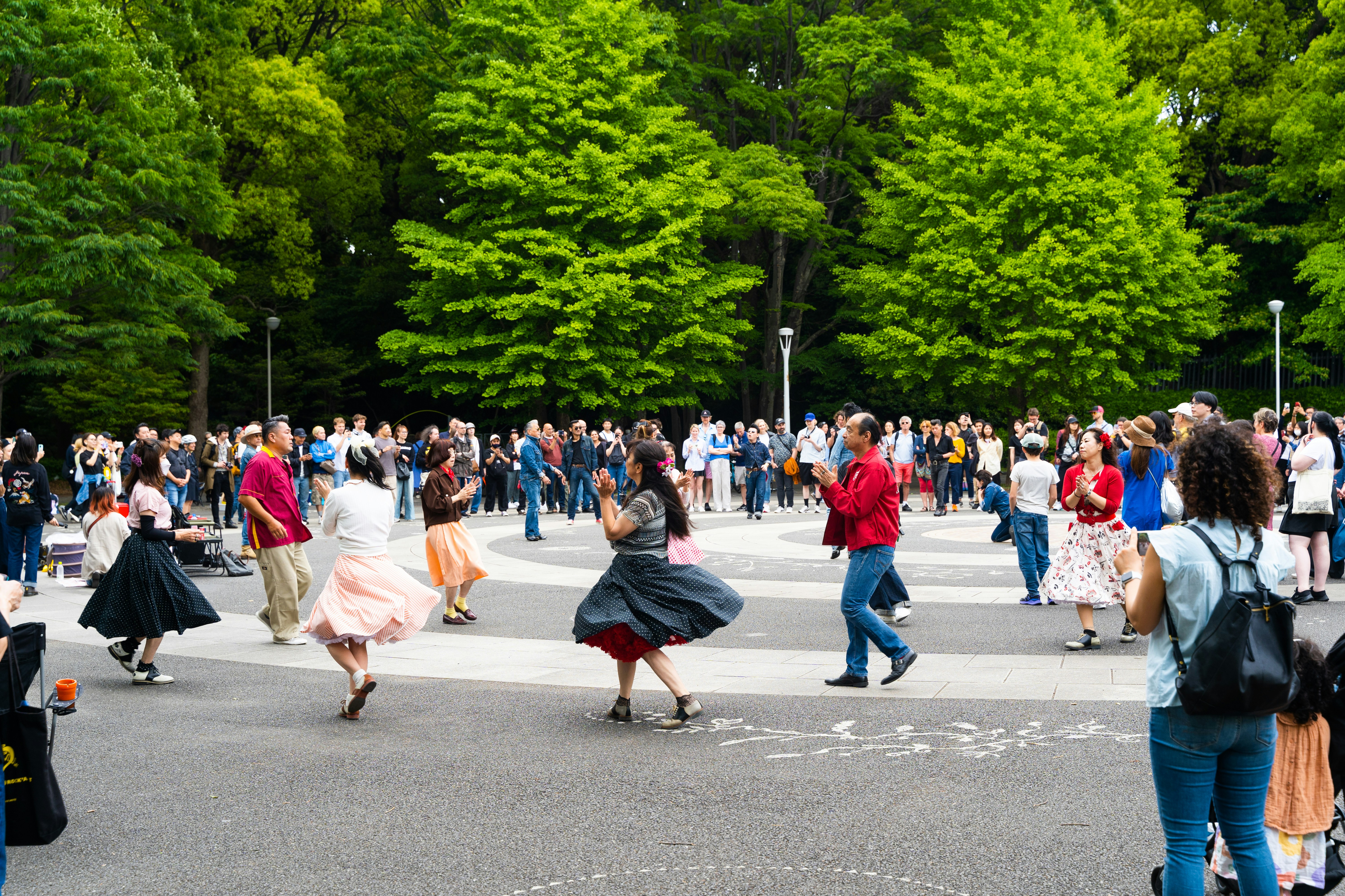 A crowd of people walking across a street
