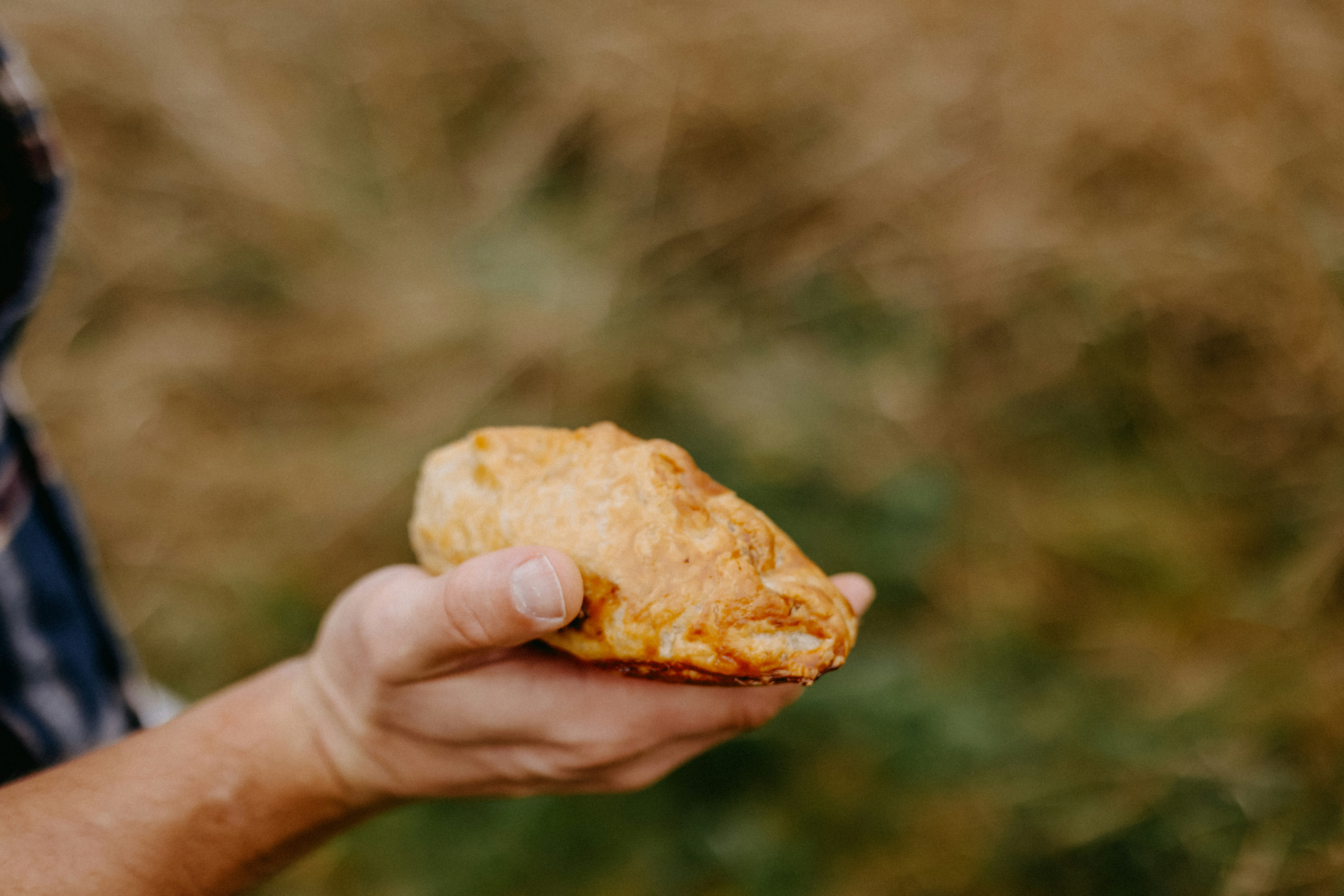 A man holding a piece of food in his hand