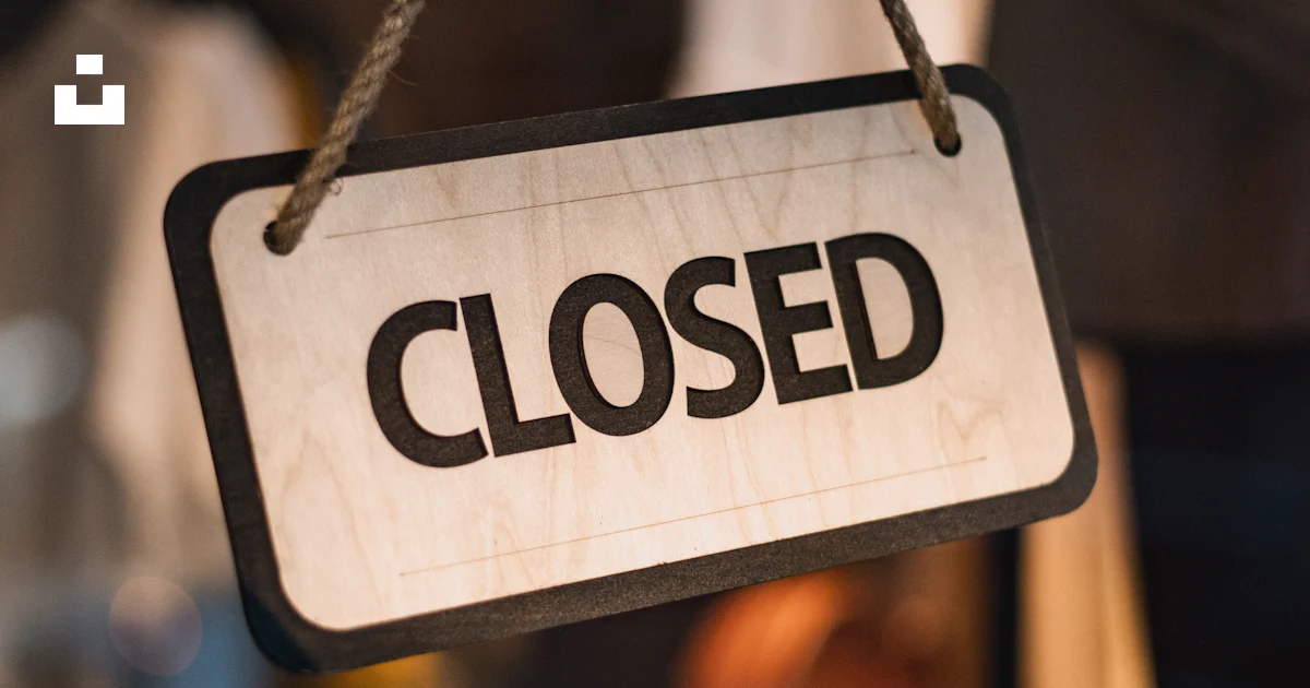 A close up of a closed sign hanging from a rope photo – Free Sign Image ...