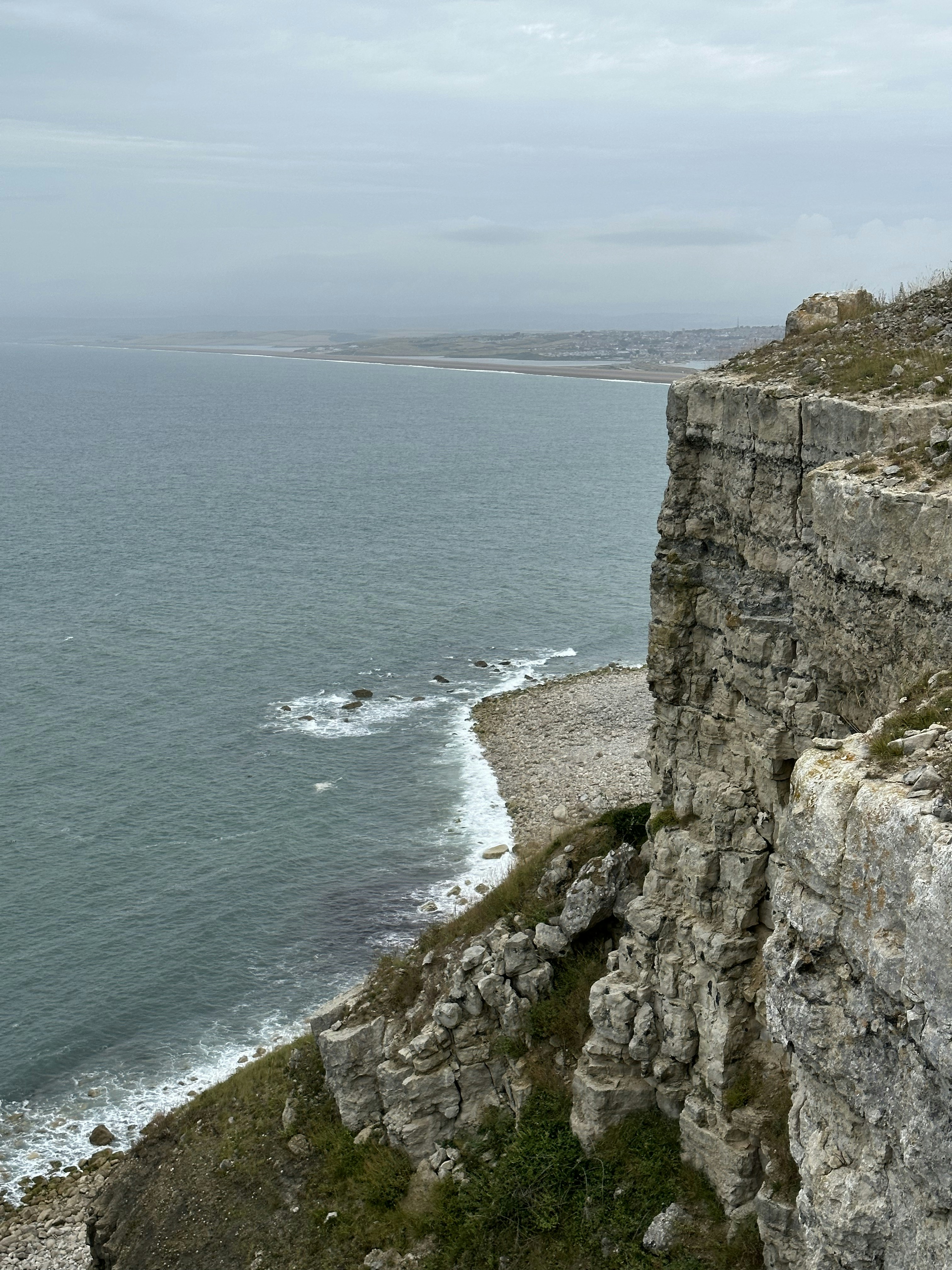 A rocky cliff overlooks a body of water