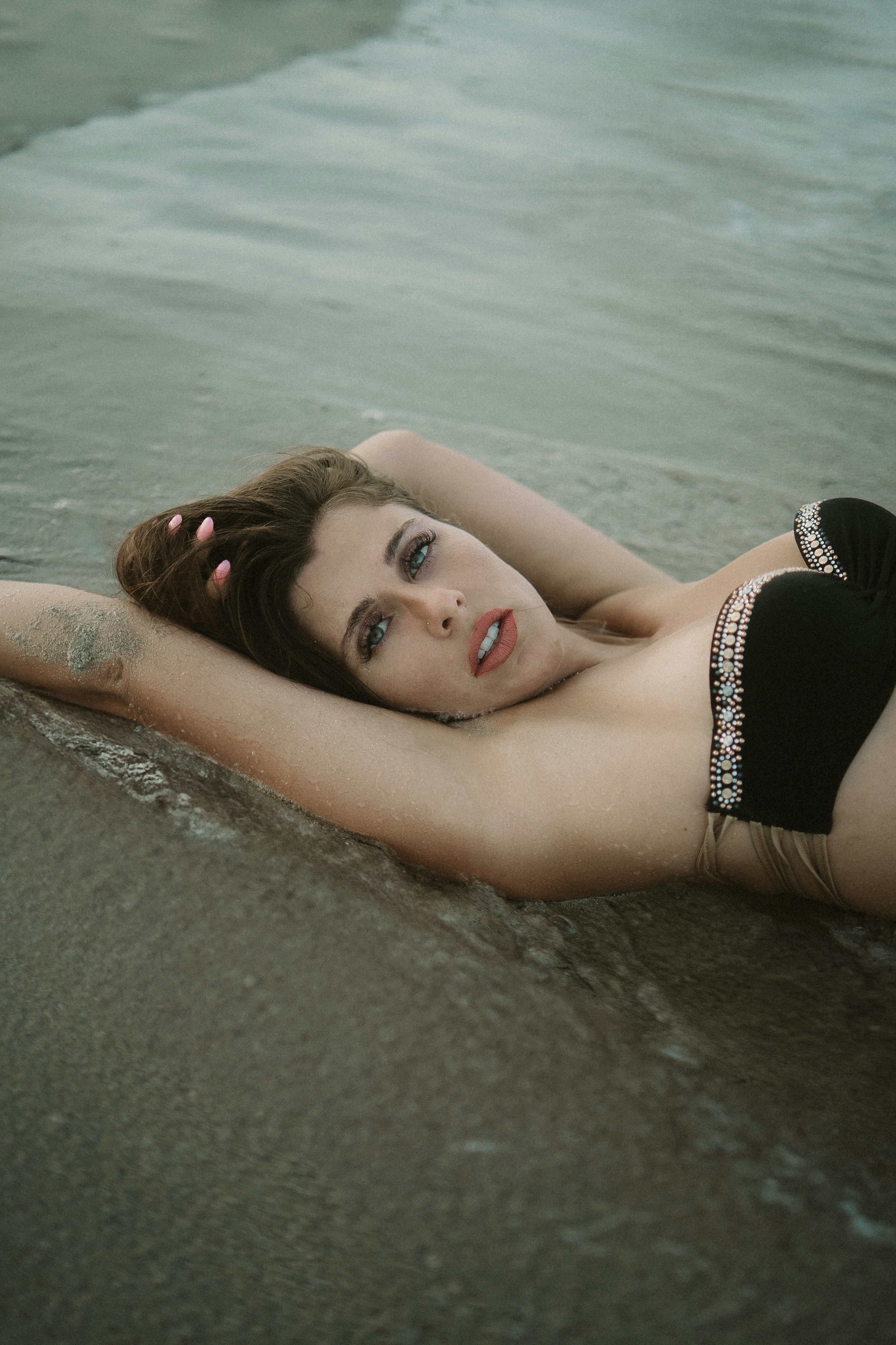 A woman in a bikini laying on the beach