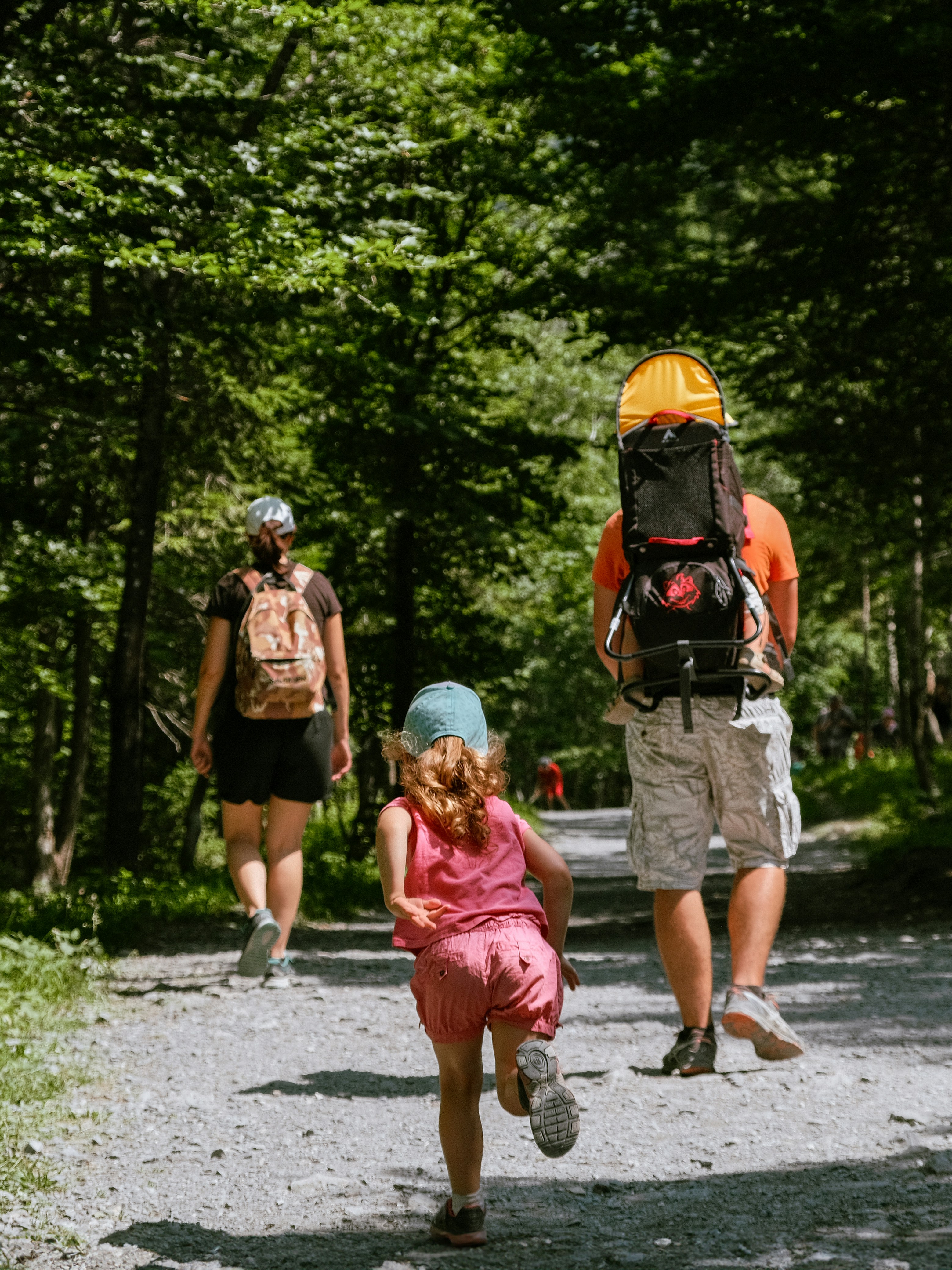 A group of people walking down a dirt road
