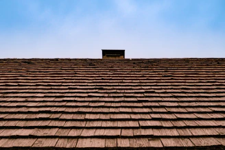 The roof of a building with a sky in the background