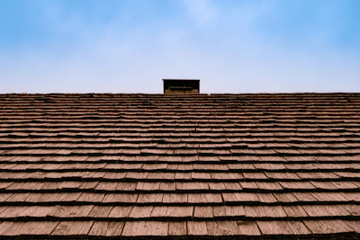 The roof of a building with a sky in the background