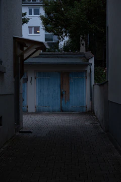 A dark alley way with a blue door