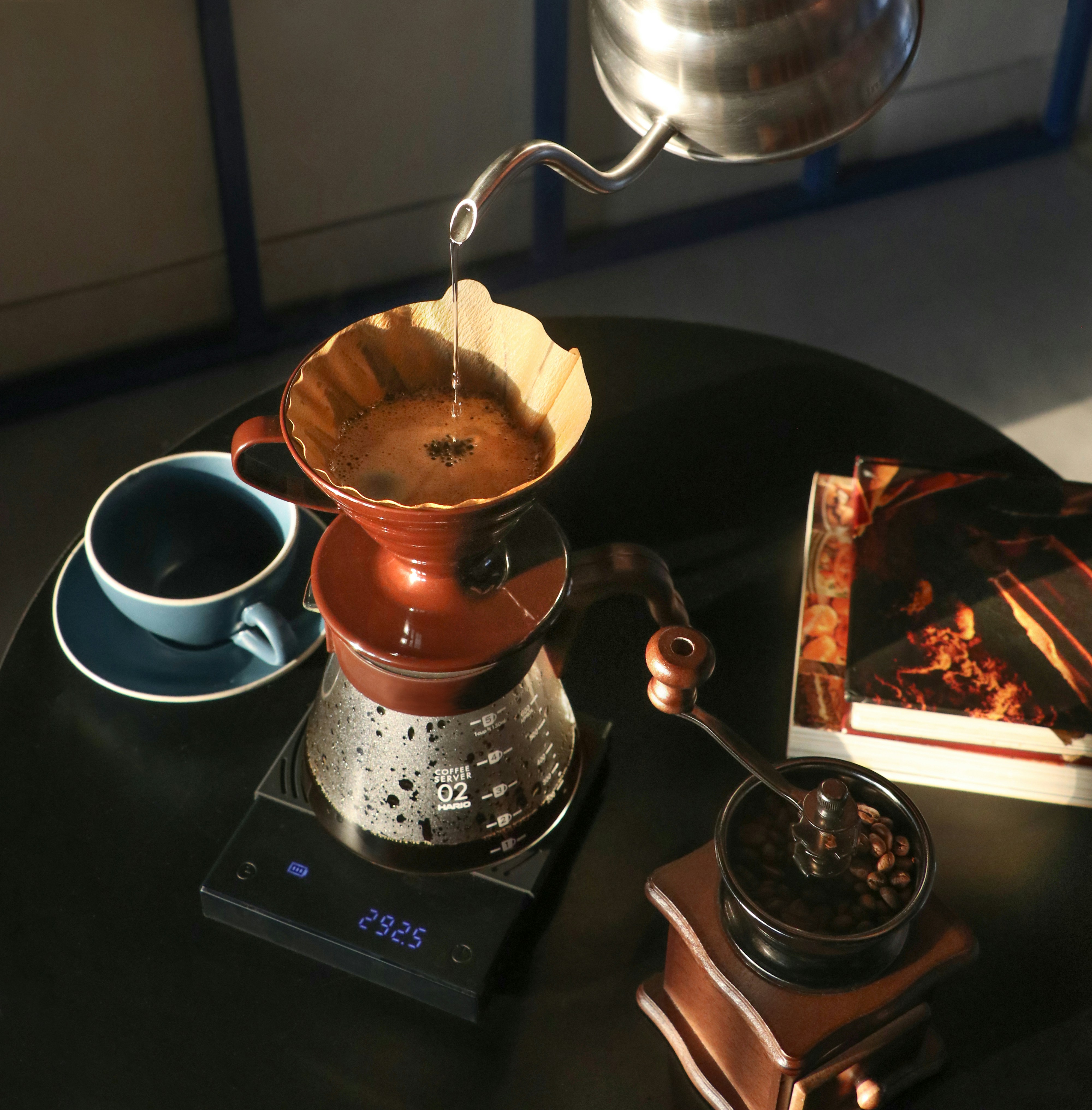 A table with a coffee pot and a book on it