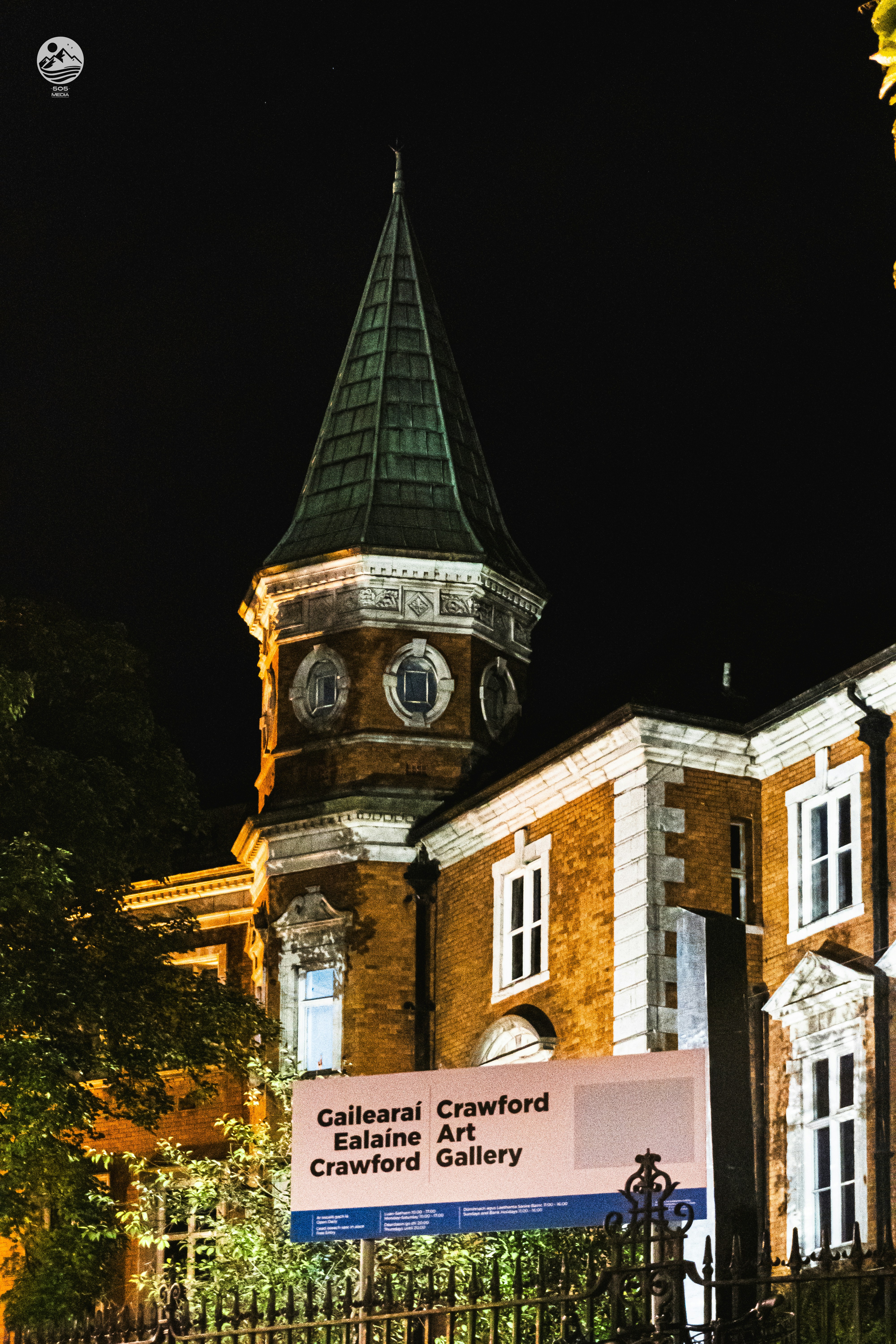 A large building with a clock tower at night