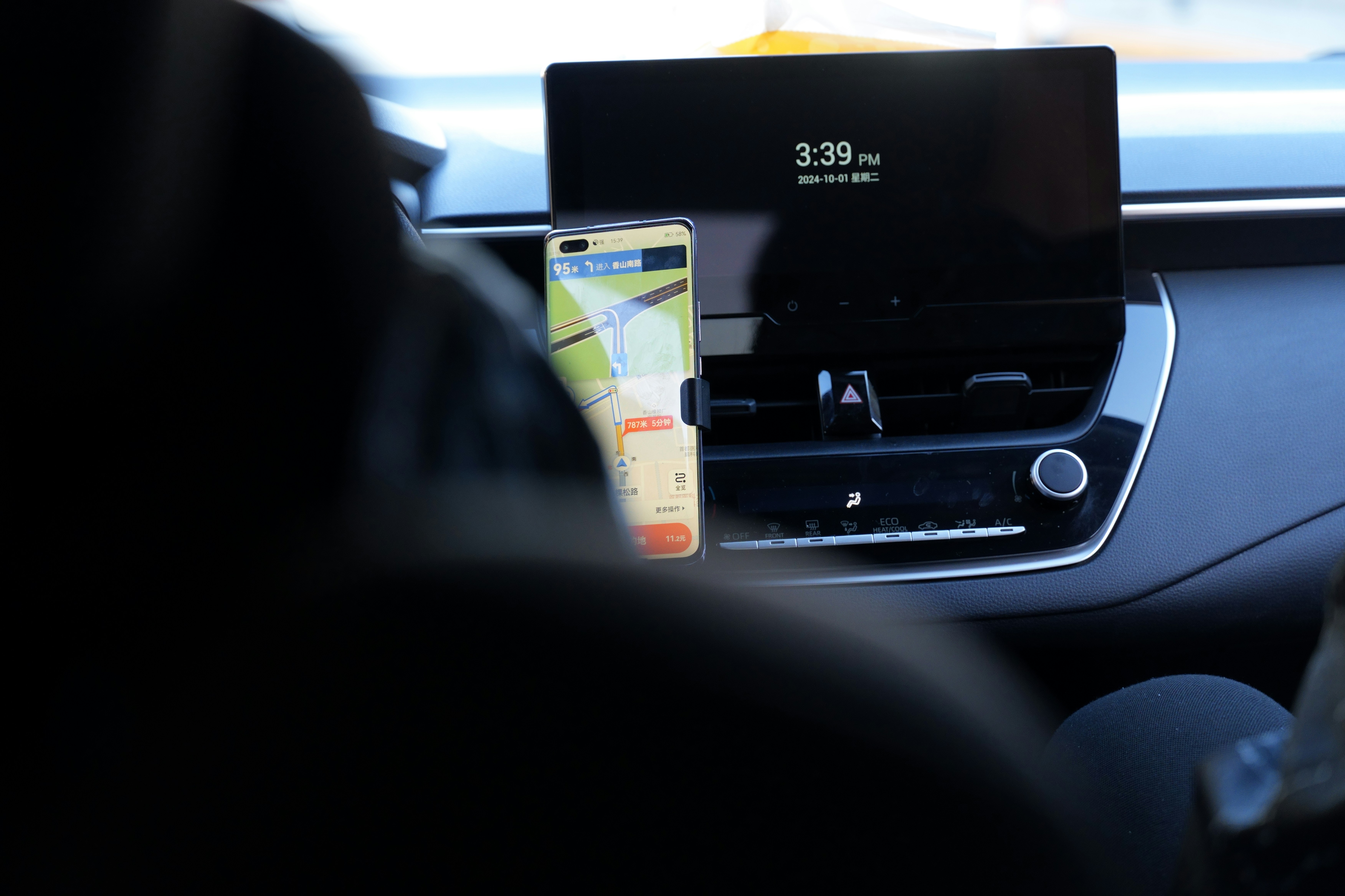 A laptop computer sitting on top of a car dashboard