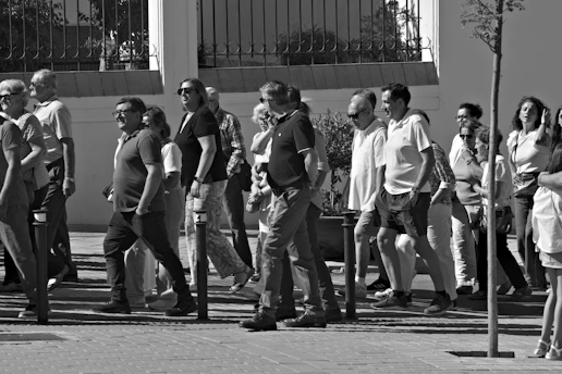 A group of people walking down a street