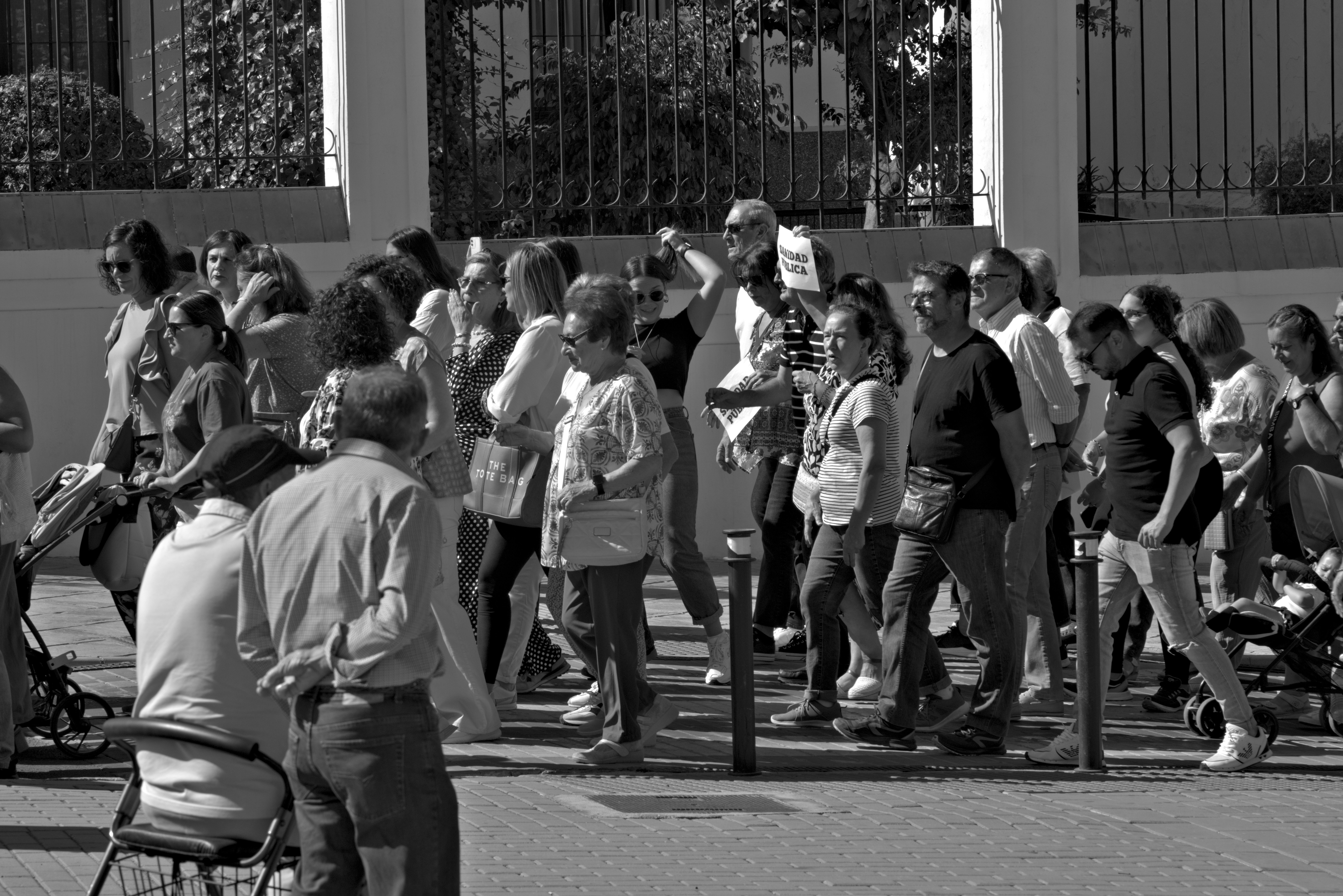 A large group of people walking down a street