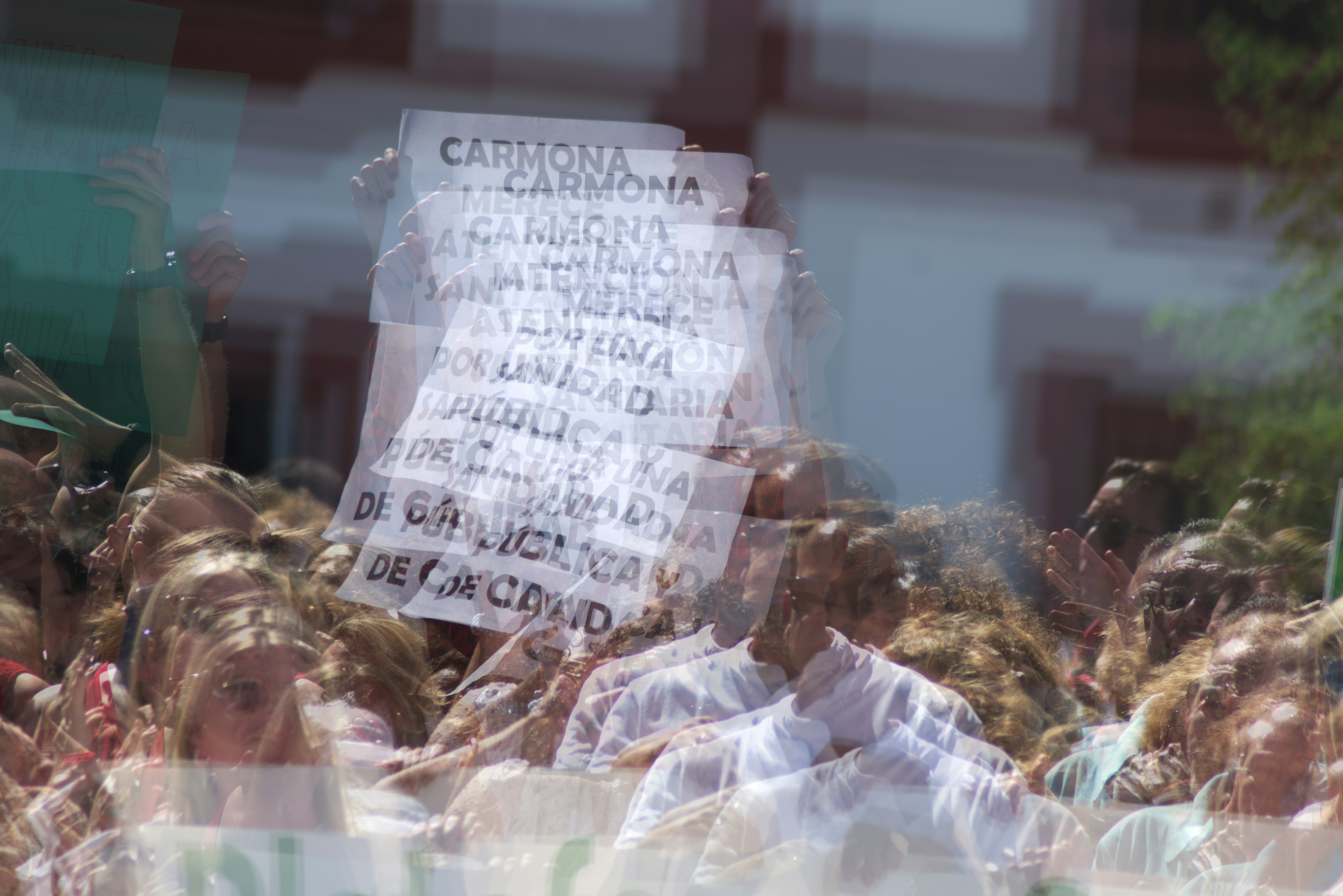 A close-up shot of an Election Commission notice document with a blurred background of a political rally.