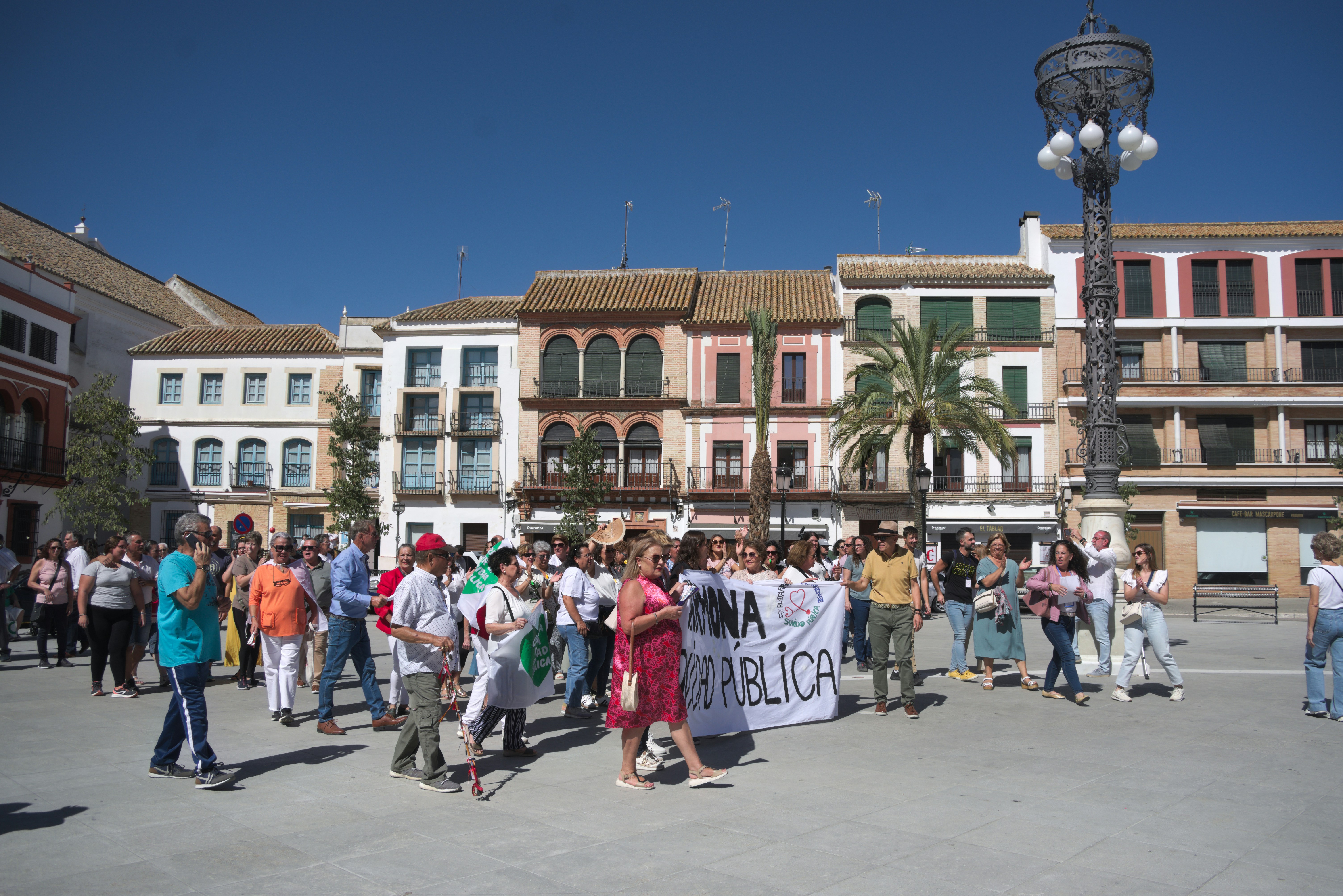A group of people standing around in a plaza