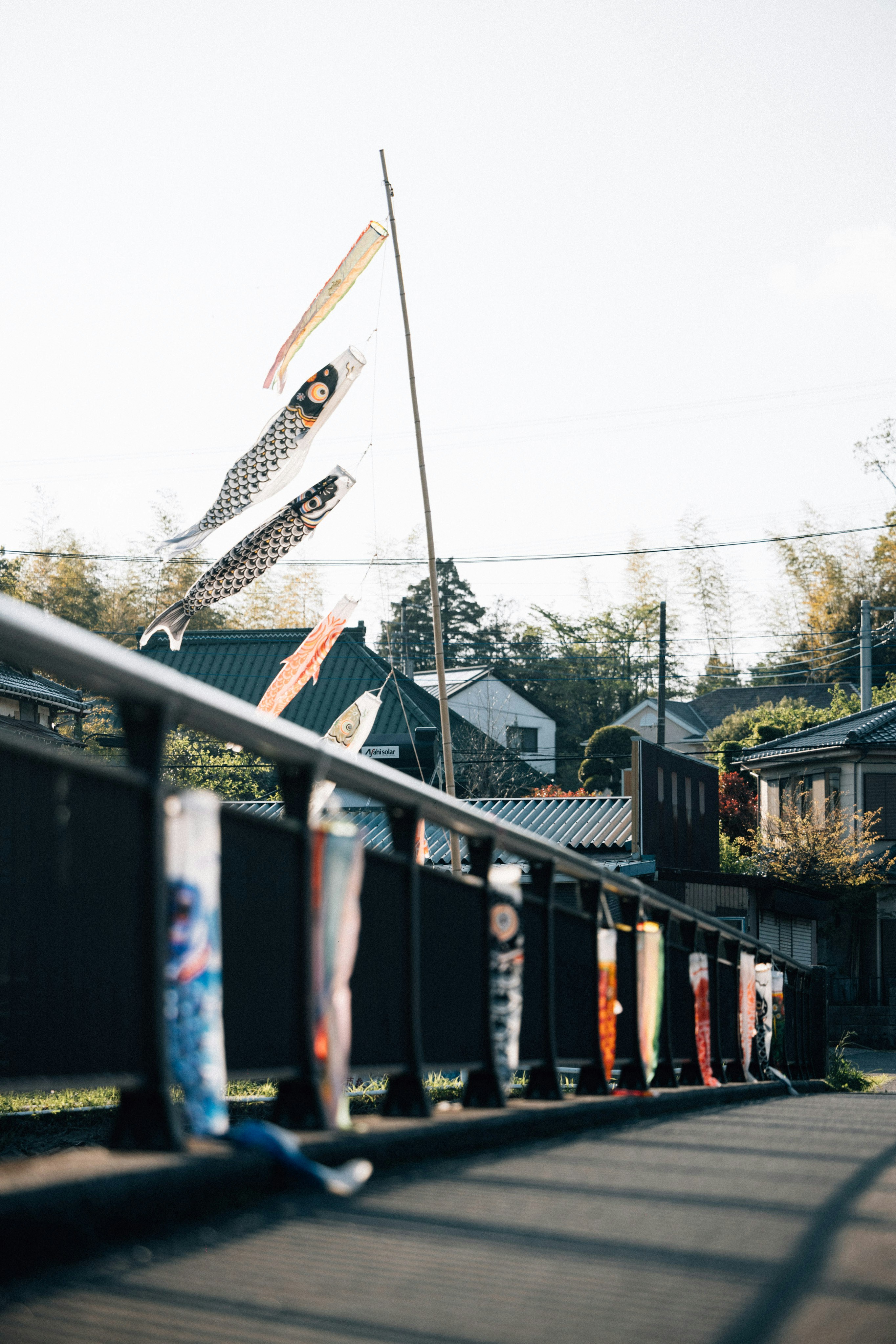 A row of flags on a metal fence